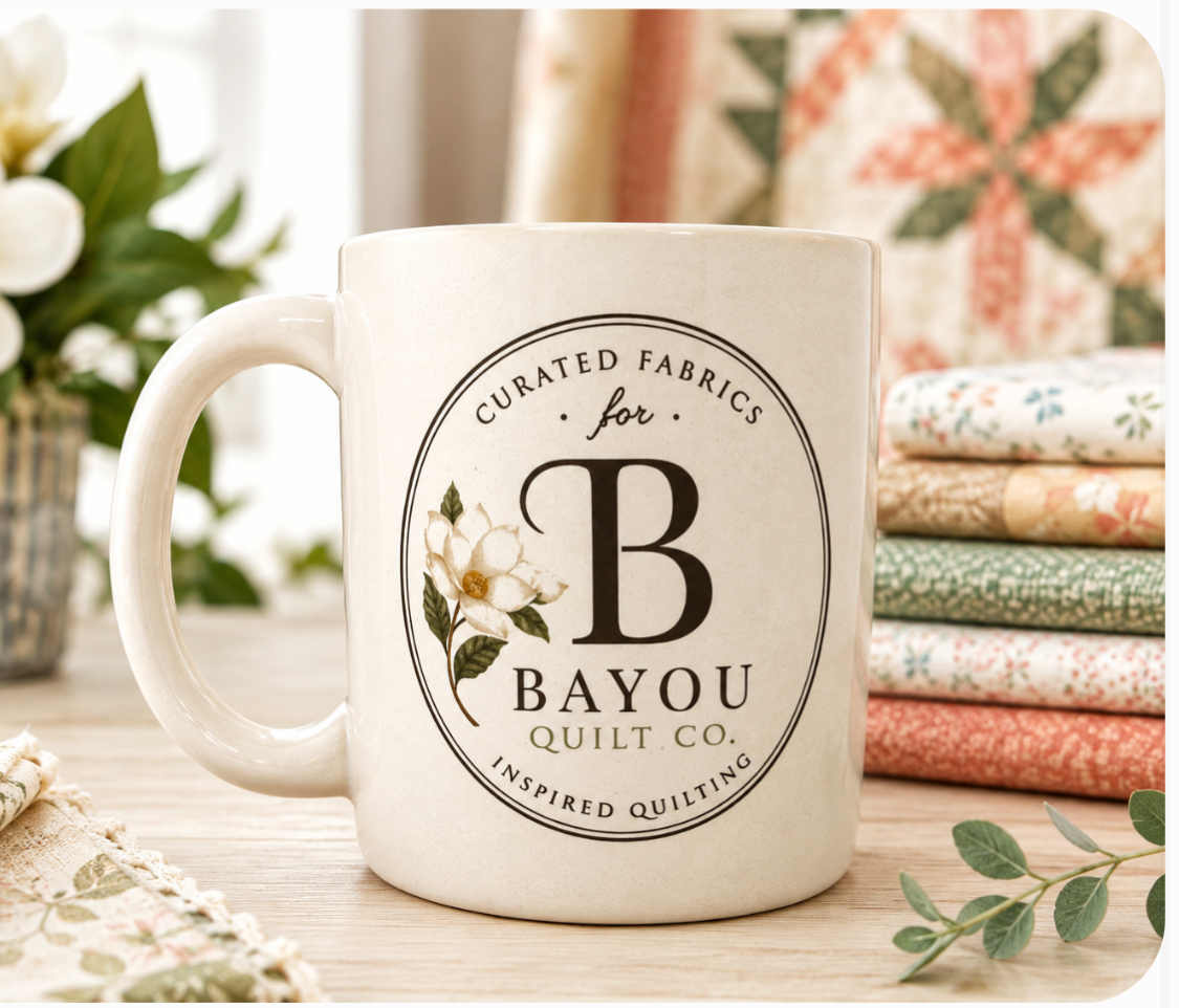 Bayou Quilt Co. coffee mug with round seal logo and magnolia accent