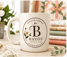 Bayou Quilt Co. coffee mug with round seal logo and magnolia accent